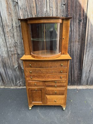 Ransom & Randolph Co. Oak Dental Cabinet with revolving curved glass door