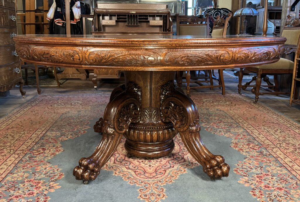 Exceptional 60" Round Oak Dining Table with Carved Apron & 5 original leaves